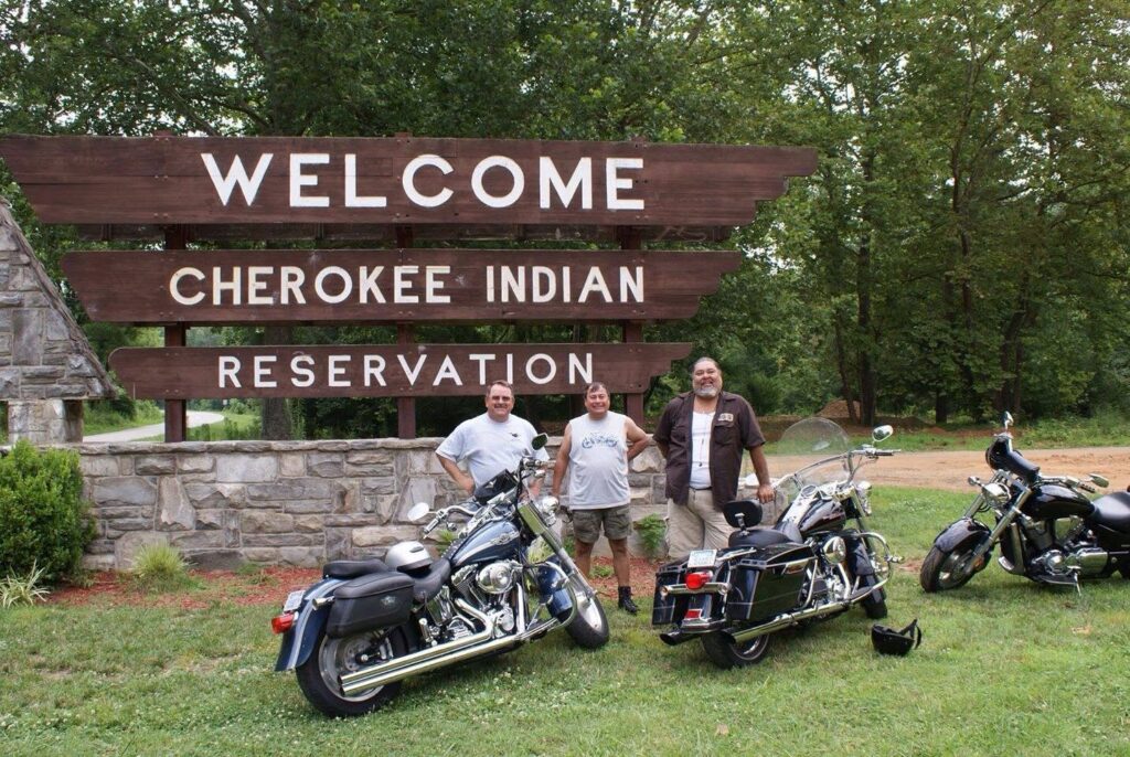 Gary Stopp with fellow riders at a Cherokee Indian Reservation sign
