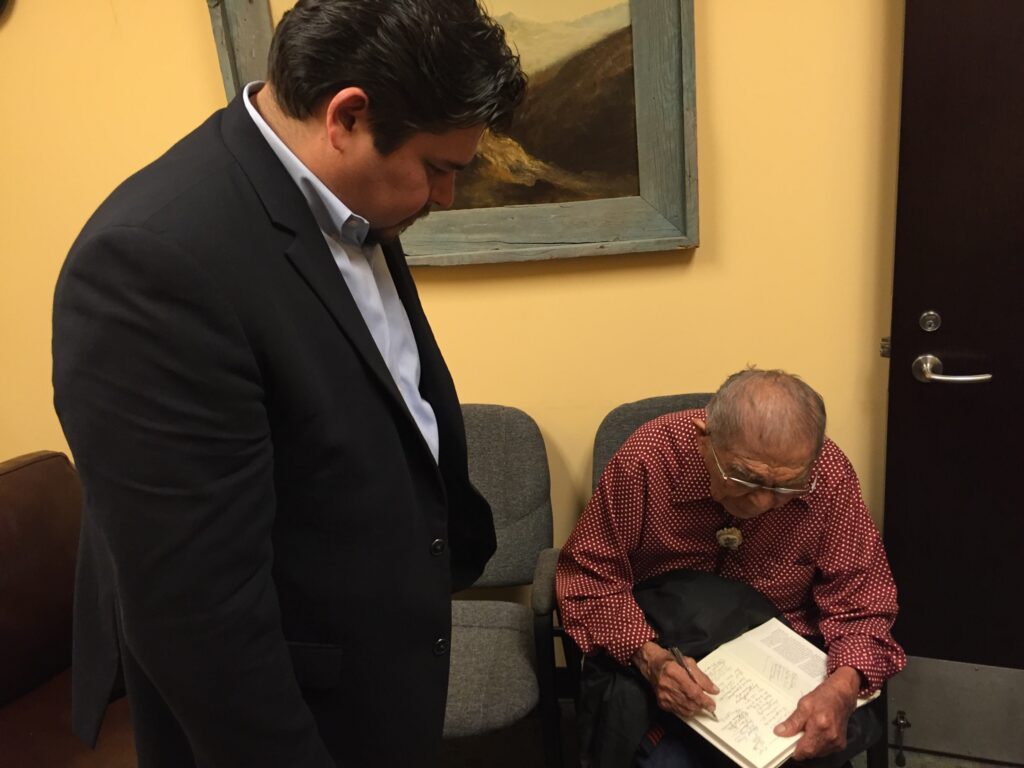 Michael Stopp with Navajo Code Talker Fleming Begaye Sr. signing a document